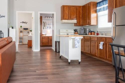 a kitchen with wooden cabinets and a white counter top at Cozy Cottage in Waco