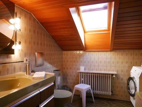 a bathroom with a sink and a toilet and a window at Gästehaus Renate in Lauf
