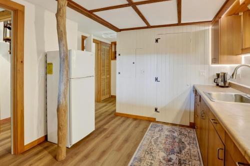 a kitchen with white cabinets and a refrigerator at Steps to Beach: Martha's Vineyard Private Retreat! in Vineyard Haven