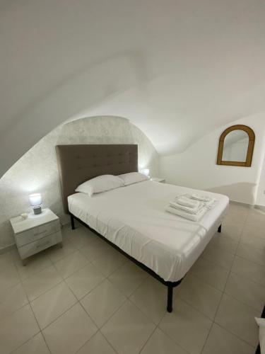 a bedroom with a bed with a white bedvisor at MareLuna in Gaeta