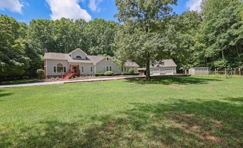 a house with a large yard with a tree at Lg Pool House w Hot Tub Central to RTPPool OPEN in Durham