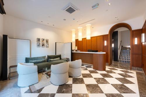 a lobby with a couch and some chairs at Hotel Madeira in Budva