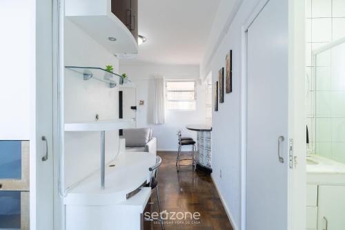a white bathroom with a sink and a table at Apt in Downtown Floripa CAT0905 in Florianópolis