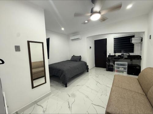 a bedroom with a bed and a mirror and a desk at Lujoso departamento con alberca y jacuzzi in Monterrey