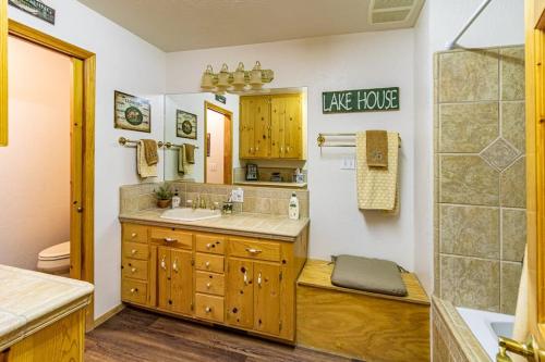 a bathroom with a sink and a toilet and a mirror at Brier Escape in Bass Lake