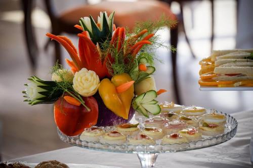 a tray of vegetables on a plate on a table at Grand Hotel Duomo in Pisa