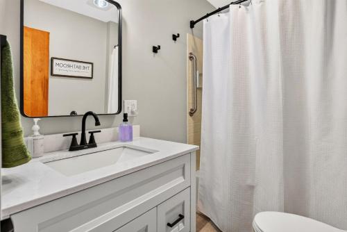 a bathroom with a sink and a shower curtain at Cozy Corner in Terre Haute
