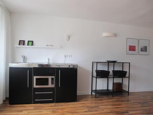 a kitchen with a sink and a microwave at Mosel - River - Quartier 31 in Lieser