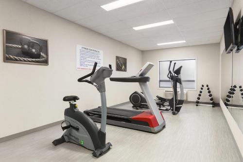 a gym with two exercise bikes in a room at Days Inn & Suites by Wyndham Yorkton in Yorkton