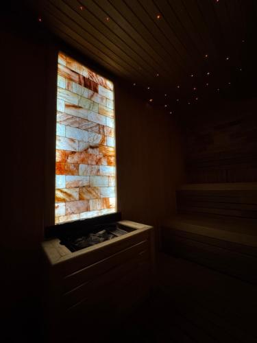 a window in a room with a stone wall at NLux Nest Milmari in Kopaonik