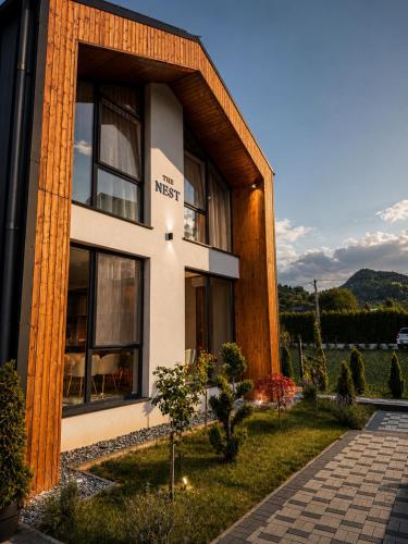 a building with a sign on the side of it at The NEST Villa in Borşa