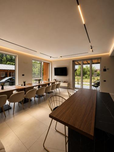 a conference room with tables and chairs and a flat screen tv at The NEST Villa in Borşa