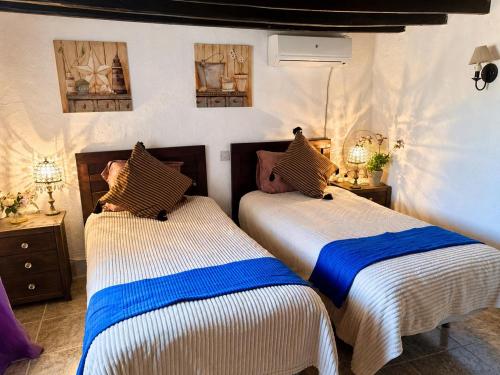 two beds sitting next to each other in a bedroom at La Finca Roja una in Málaga