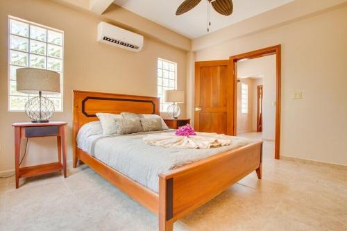 a bedroom with a large bed with a flower on it at Magnificent Belize Townhouse-Pool-Private Island in Placencia