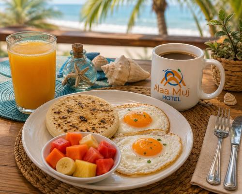 a breakfast plate with eggs and fruit and a cup of coffee at Palaa Mujuii Hotel in Dibulla