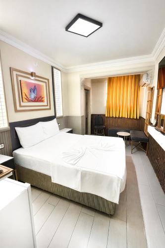 a bedroom with a large white bed in a room at Exporoyal Hotel in Antalya