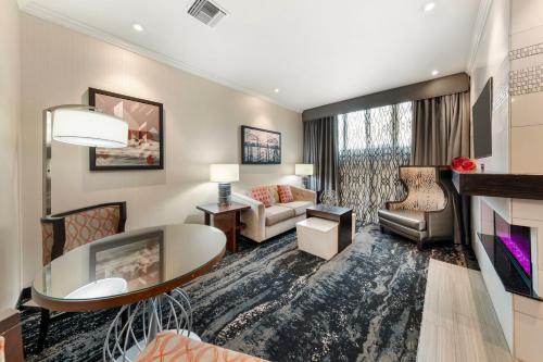 a living room with a couch and a table at Best Western Plus Redondo Beach Inn in Redondo Beach