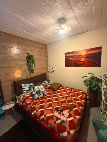 a bedroom with a bed with a quilt on it at Refúgio do mar casa de praia em Saquarema in Saquarema