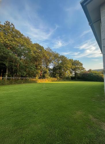 a large field of green grass with trees in the background at Casa Vila in Pol