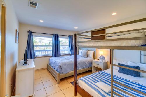 a bedroom with two bunk beds and a television at 'Sea-King Sol' Ocean-View Condo in Port Aransas! in Port Aransas