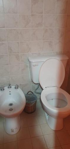a bathroom with a toilet and a sink at Casa M in Tilcara