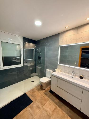 a bathroom with a shower and a toilet and a sink at Cal Piano in Palol de Rebardit