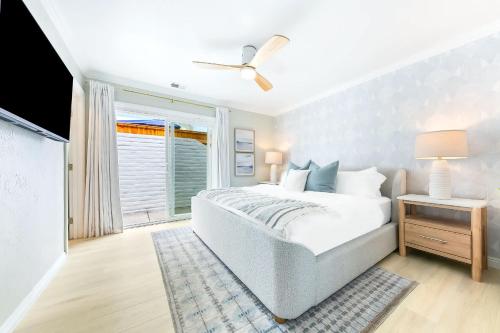 a bedroom with a bed and a window at Designer Del Mar Escape Beach Dining & Shops in San Diego