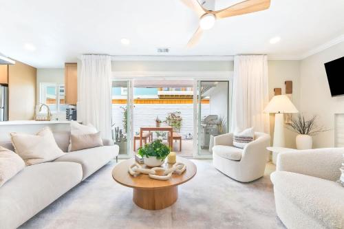 a living room with a white couch and a table at Designer Del Mar Escape Beach Dining & Shops in San Diego