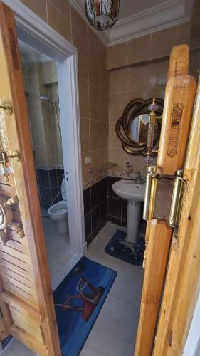a bathroom with a sink and a toilet and a mirror at Villa Marsilea in Dawwār Muḩammad Abū Shanab