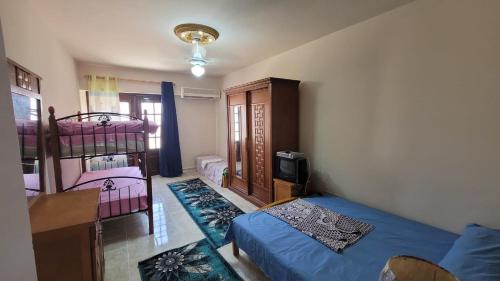 a bedroom with a bed and a bunk bed at Villa Marsilea in Dawwār Muḩammad Abū Shanab