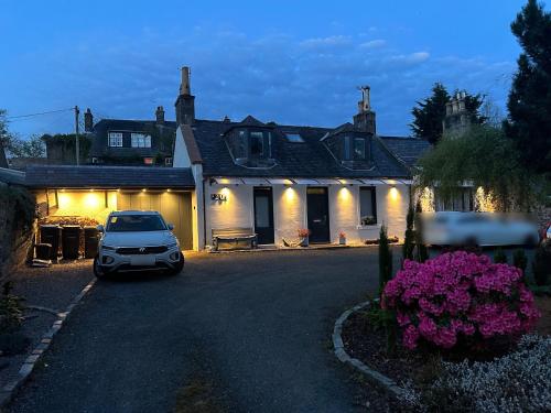 a car parked in front of a house at night at Lily Bank Room in Stonehaven
