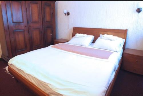 a bed with two white pillows on it in a room at Apartman Kopaonik Brzeće in Brzeće