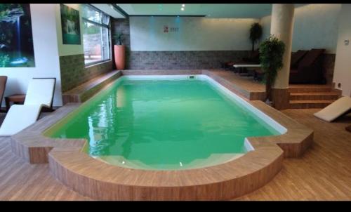 a large swimming pool in a room with at Apartman Kopaonik Brzeće in Brzeće