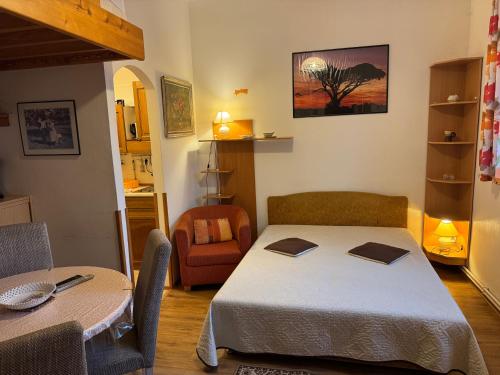 a room with a bed and a table and a chair at Chalupa U Potoka in Josefŭv Dŭl