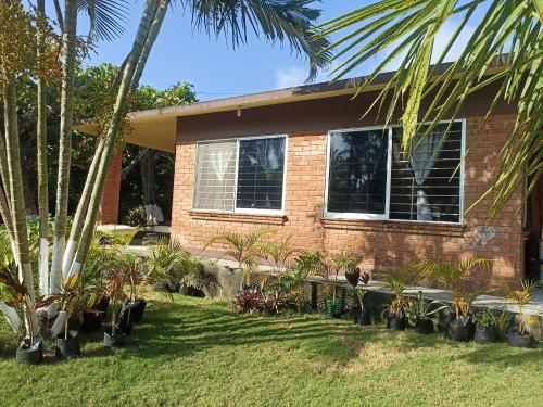 a house with a bunch of plants in front of it at La Morada, una ventana al golfo - Hotel boutique in Monte Gordo