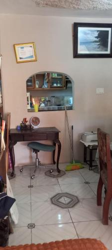 a room with a desk and a mirror on the wall at Hideaway at the Harbour in Sussex