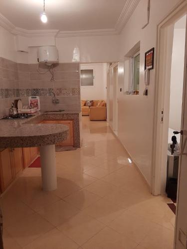 a kitchen with a sink and a counter in a room at agadir location vacance aourir plage in Aourir