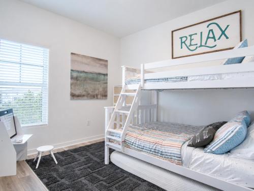a bedroom with two bunk beds and a desk at The Palm LK Private Beach Club 100"TV in Pensacola