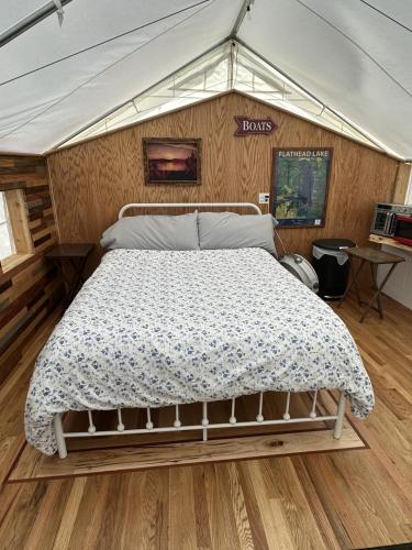 a bedroom with a bed in a tent at GlampCamp in Big Arm