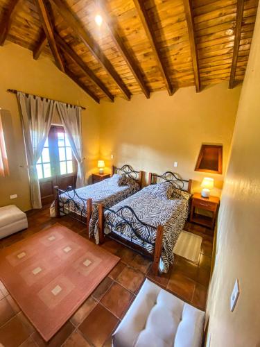 an overhead view of a bedroom with two beds at B&B Cotacachi Hosteria Oro Azul in Cotacachi