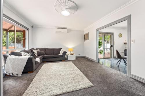 a living room with a couch and a table at The Laneway - 3BR, Pet Friendly, Walk to CBD in Port Lincoln