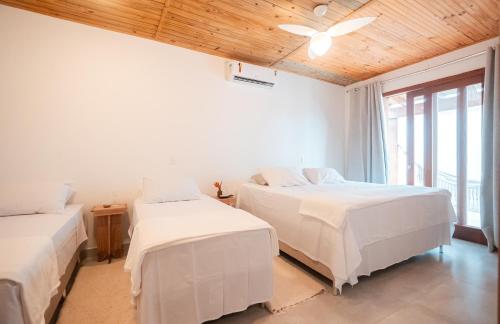 a bedroom with two beds and a ceiling fan at Casa Orybá in Prado