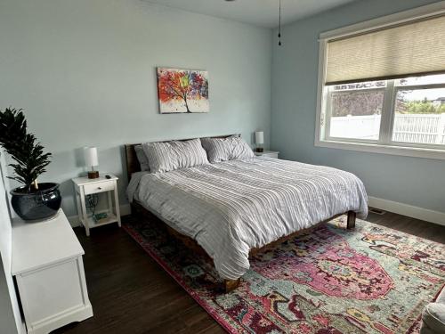 a bedroom with a bed with a rug and a window at Hometown Place in Missoula