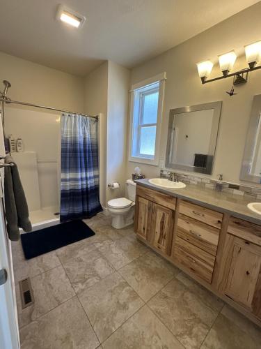 a bathroom with a sink and a toilet and a shower at Hometown Place in Missoula