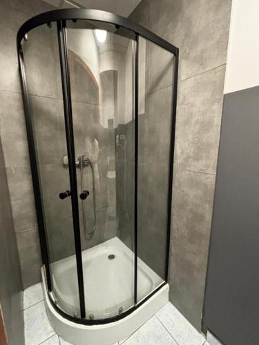 a shower with a glass door in a bathroom at StayPoz-Stary Rynek in Poznań