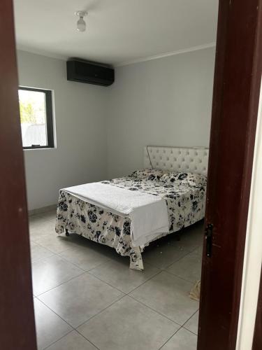a bedroom with a bed in a room at Residential Florence Nightingale in Sorriso