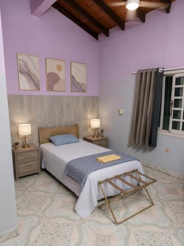 a bedroom with a large bed and two night stands at Cómo en casa CDE in Ciudad del Este
