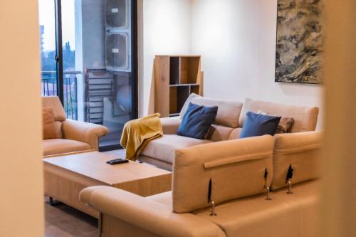 a living room with couches and a coffee table at Beaufort Ridge - Skysuites in Accra