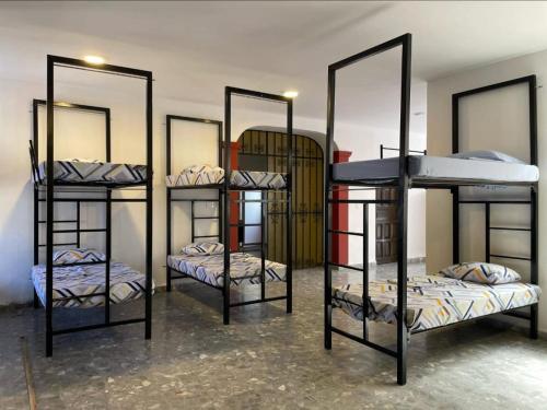 a room with four bunk beds with mirrors at Hostel Paricutín in Uruapan del Progreso