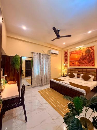 a bedroom with a large bed and a ceiling fan at Sukoon e Banaras in Varanasi